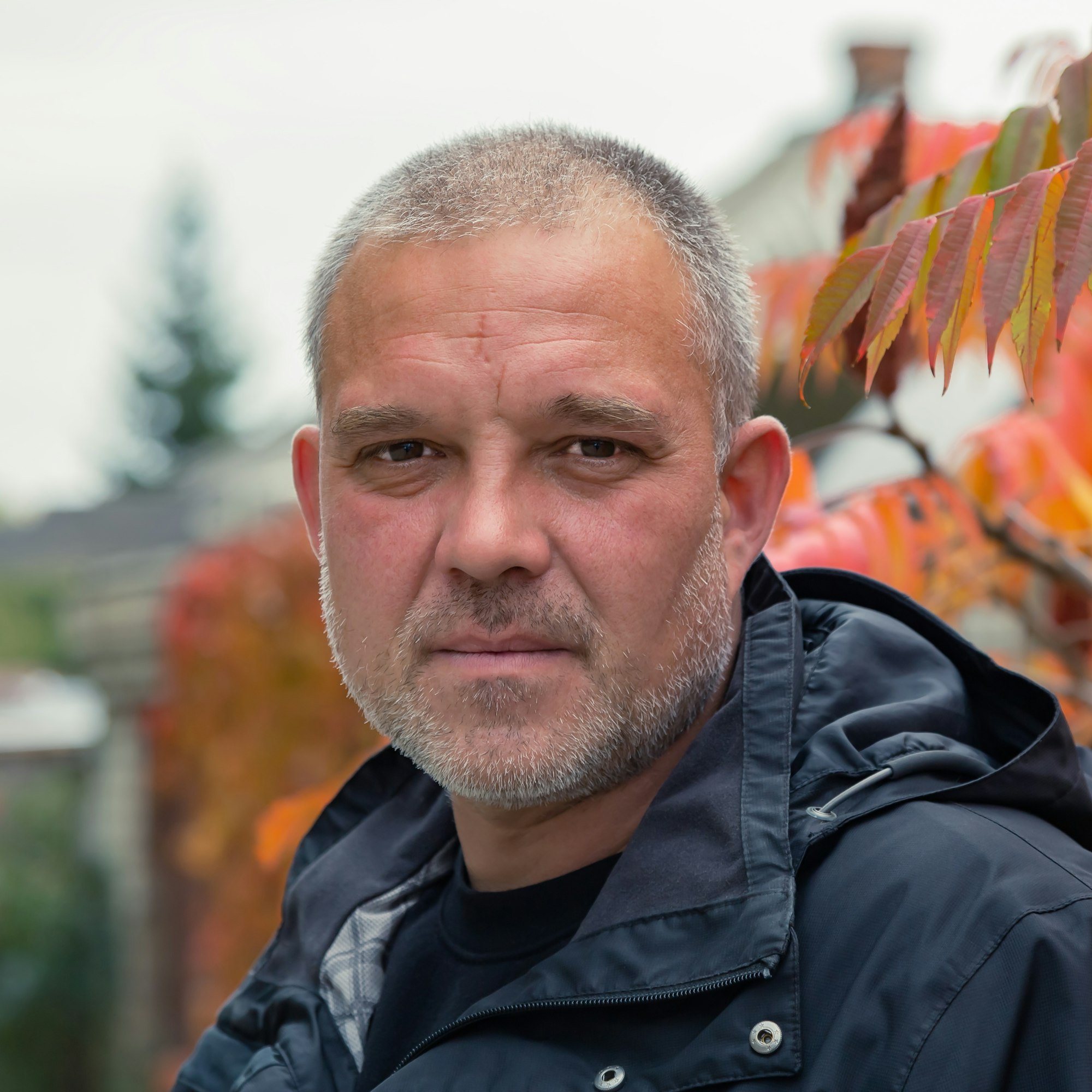 Portrait of a European man 40 years old outdoors in autumn